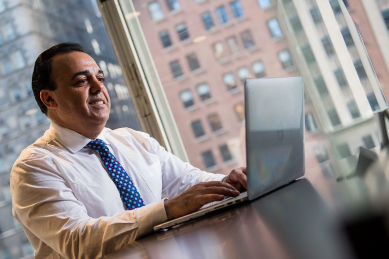 NYC Branded Lifestyle Portrait sales and marketing executive Anthony Chaine on laptop